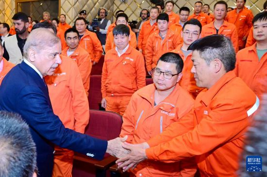 4月1日，在巴基斯坦西北部開伯爾-普什圖省達蘇，巴基斯坦總理夏巴茲（左）同達蘇水電站項目中方員工握手。新華社發(fā)（巴基斯坦新聞與廣播部下轄媒體信息部門供圖）