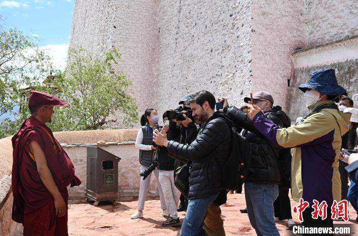 圖為中外媒體拍攝朝拜布達(dá)拉宮的僧人?！≮w朗 攝