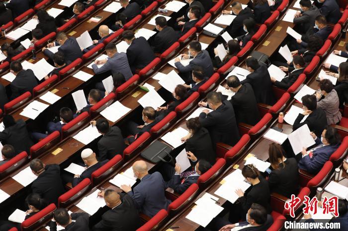 圖為會議現(xiàn)場，參會代表正在聽取政府工作報告?！∑钤鲚?攝