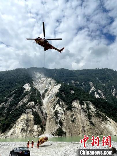 直升機(jī)正在運(yùn)輸110千伏唐下線應(yīng)急塔塔材。　衛(wèi)科 攝