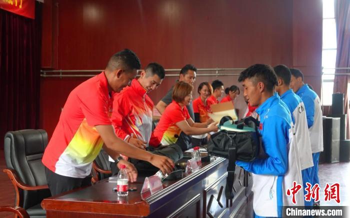 圖為世界冠軍們?yōu)槲鞑刈灾螀^(qū)體校的學生們送上暖心物資?！∪轿木?攝